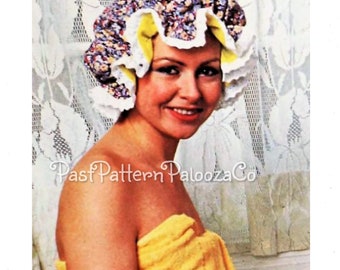 May include: A vintage sewing pattern for a shower cap. The pattern features a floral print with yellow ruffles and white lace trim. The model is wearing the finished shower cap and a yellow towel.