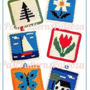 May include: Six square crochet potholders featuring various designs including a black pine tree, a white flower, a sailboat on blue water, a red tulip, a blue butterfly, and a house with a tree. Each piece has a small hanging loop at the top.