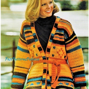 May include: A crocheted cardigan with a colourful striped pattern in shades of orange, yellow, blue, brown, and black. The cardigan has a tie belt and a V-neck.