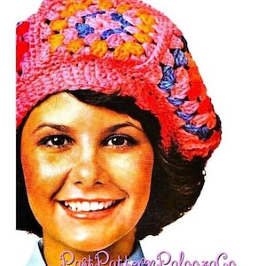 May include: A colorful, crocheted hat in shades of pink, orange, yellow, and blue. The hat is a granny square design, with a rounded crown and a brim. The text "PastPatternPaloozaCo" is visible in the image.