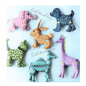 May include: Six handmade stuffed animal toys, including a pink and white gingham elephant, a brown and yellow spotted rabbit, a green and white floral cat, a blue dog, a purple and white gingham giraffe, and a teal and black patterned camel. The toys are all made with fabric and have button eyes.