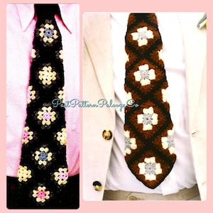 May include: A crocheted tie with a brown, white, and gray geometric pattern. The tie is made of squares with a flower design in the center.