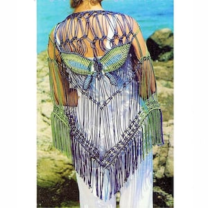 May include: A crocheted butterfly shawl with purple and green fringe. The shawl is made with a knotting technique and features a butterfly design in the center.