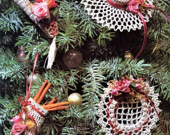 May include: Four crocheted Christmas ornaments in white with pink accents. The ornaments are a cone with red berries, a hat, a small bag, and a doily. The ornaments are hanging on a green Christmas tree. The text "Precious Reminiscence Lace Coquetry" is at the bottom of the image.
