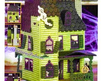 May include: A handmade, three-dimensional haunted house, crafted with a needlepoint technique. The house features a lime green exterior with purple shutters and a black roof. A ghost and jack-o'-lantern add to the Halloween theme. The house is a decorative item.
