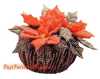May include: A red and white gingham poinsettia flower arrangement in a black and white gingham pot. The arrangement is a handmade craft item.