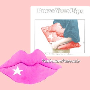 May include: A pink plush pillow shaped like a pair of lips with a white star in the center. The pillow is on a pink background. The text "Purse Your Lips" is visible in the background.