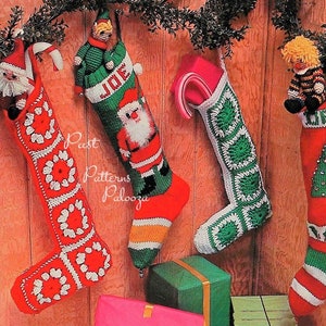 May include: Four crocheted Christmas stockings hanging on a wood panel wall. The stockings are decorated with different designs, including a Santa Claus, a Christmas tree, and a snowman. The stockings are all red and green with white accents. The stockings are all about 18 inches long.