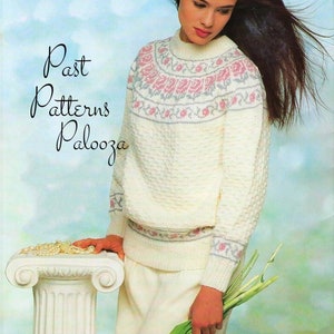 May include: A white knitted sweater with a pink and gray floral pattern around the neckline and cuffs. The sweater is worn by a woman with long dark hair. The text "Past Patterns Palooza" is visible in the top left corner of the image.