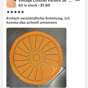 May include: An orange, circular crochet pattern, approximately 38 inches in diameter, with a detailed, openwork design. The pattern features a central circle with radiating lines and decorative edging. The text "Vintage Crochet Pattern" is visible.