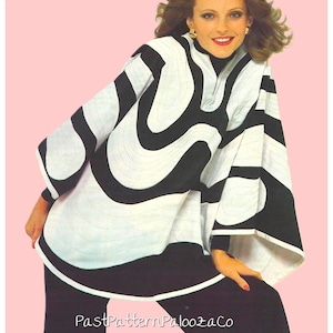 May include: A black and white patterned poncho-style top with a high collar and wide sleeves. The top features a bold, wavy design. The model is wearing black pants. The background is a light pink color.