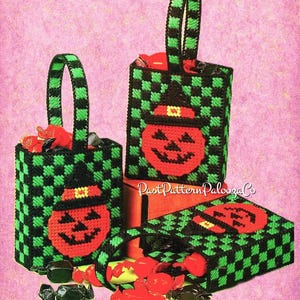May include: Three Halloween-themed treat bags with a green and black checkered pattern. Each bag features a red jack-o'-lantern face wearing a black witch hat. The bags are filled with wrapped candies. The text "Past Pattern Palooza Co" is visible.