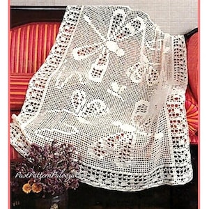 May include: A white, open-weave crochet doily with a floral and geometric design. The doily is draped over a red and orange striped surface. The text "PastPatternPaloozaCo" is visible in the lower left corner.