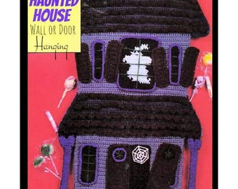 May include: Vintage crochet pattern for a Halloween haunted house wall hanging. The pattern features a purple and black crocheted house with a ghost in the window and a spider web on the side.