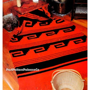 May include: A red and black crocheted throw blanket with a geometric pattern. The blanket is on a wooden floor with a wicker basket in the foreground.