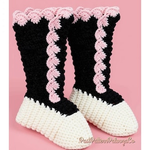 May include: A pair of handmade crochet boots featuring a black upper section, a white toe and sole, and light pink scalloped trim along the top edge and vertical front seam. The text PastPatternPaloozaCo is visible at the bottom right corner.