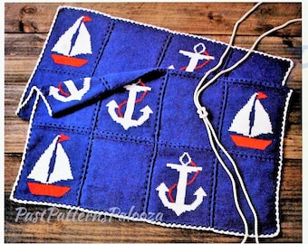 May include: A blue nautical-themed knitted blanket with white anchors and sailboats with red accents. The blanket has a white border and a white cord attached. The text "Past Patterns Palooza" is visible in the bottom left corner.