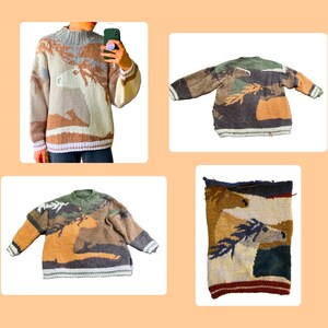 May include: A long-sleeve knit sweater featuring a multi-colored intarsia design of horses in a landscape. The sweater has a ribbed crew neckline, cuffs, and hem, with earthy tones of brown, tan, cream, and green throughout the knit pattern.