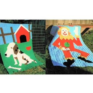 May include: Two crocheted blankets, one with a dog and doghouse design and the other with a clown design. Both blankets are hanging on a clothesline.