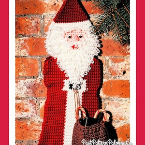 May include: A crocheted Santa Claus wall hanging featuring a red and white hat, a white looped yarn beard, and a red coat with white trim. A brown crocheted sack is attached to the front, containing two candy canes. The text PastPatternPaloozaCo is visible.