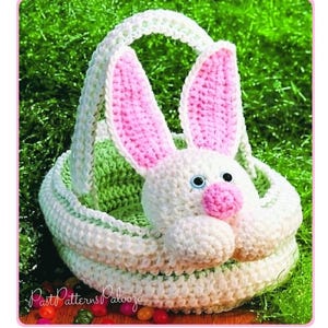 May include: A crochet basket featuring a white bunny head with pink inner ears and a pink nose, attached to the front. The basket has a white handle and a light green interior. The text PastPatternsPalooza is visible in the lower left corner.