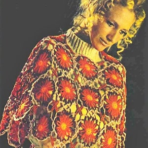 May include: A crocheted shawl with a floral design in shades of orange, red, and white. The shawl is made with a delicate openwork stitch and features a scalloped edge.