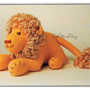 May include: A plush lion toy with a brown and white mane. The lion is lying down with its head turned to the side. The toy has a stitched-on nose and eyes.