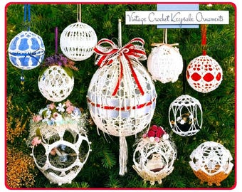 May include: A collection of spherical crochet ornaments hanging from a tree. The white lace designs feature various patterns, some accented with red ribbons, floral embellishments, or small figurines. Text at the top reads Vintage Crochet Keepsake Ornaments.