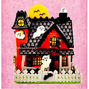May include: A handmade Halloween-themed house with a red exterior, black roof, and white fence. The house features yellow window lights, a yellow moon, and white ghost decorations. The text "Past Pattern Palooza Co" is visible on the side.