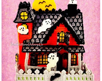 May include: A handmade Halloween-themed house with a red exterior, black roof, and white fence. The house features yellow window lights, a yellow moon, and white ghost decorations. The text "Past Pattern Palooza Co" is visible on the side.