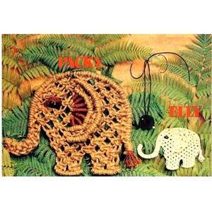 May include: A large tan macrame elephant figure labeled PACKY, a small black hanging elephant ornament, and a small white crocheted elephant figure labeled ELLY. The figures feature dark bead eyes and are displayed against green fern foliage.