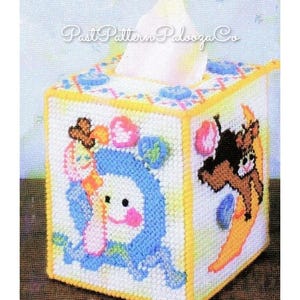 May include: A yellow, blue, and white plastic tissue box cover with a cartoon animal design. The cover features a snowman, a deer, and a butterfly.