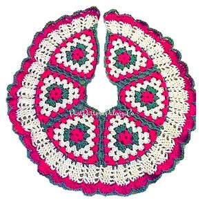 May include: A crocheted Christmas tree skirt in red, white, and green with a scalloped edge. The skirt is made of granny squares and has a center hole for the tree trunk.