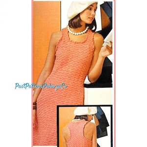 May include: A peach-colored, sleeveless dress with a textured pattern. The dress has a scalloped neckline and is worn with a pearl necklace and a white beret. The image includes a smaller inset showing the back of the dress.