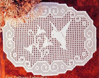 May include: White crocheted doily with a delicate floral design. The doily is made with a fine thread and has a scalloped edge.