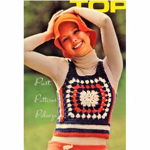 May include: A crochet vest with a granny square pattern in blue, white, red, and orange. The vest is sleeveless and has a scoop neck. The model is wearing a white turtleneck shirt and a bright orange hat.