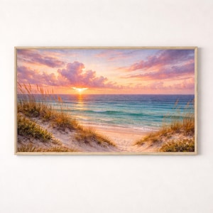 May include: A framed print depicting a beach scene at sunset. The sky is filled with pink and orange clouds, and the sun is setting over the sea. The beach features sand dunes and tall grass.