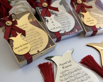 May include: Tulip-shaped gold and silver mirrored acrylic plaques featuring the Ayat'ul Kursi prayer in Arabic calligraphy. Each plaque is adorned with a deep red ribbon, a small decorative flower, or a red tassel, and personalized with names and dates.