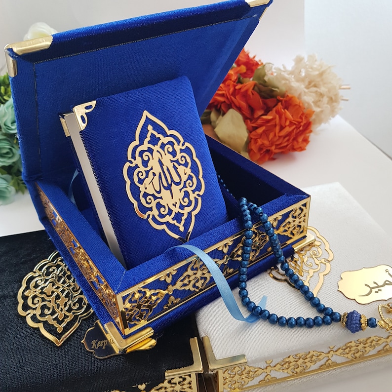 May include: A blue velvet box with gold trim and intricate designs. The box contains a smaller blue velvet book with gold lettering and a gold prayer beads.