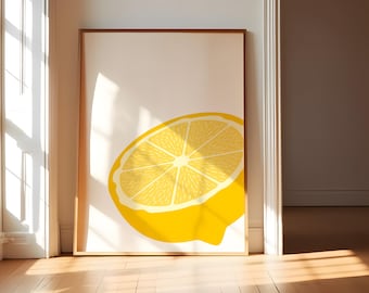May include: A rectangular framed wall art print featuring a graphic illustration of a bright yellow lemon half centered on a cream-colored background. The lemon slice displays detailed segments and a white rind, enclosed in a simple wooden frame.