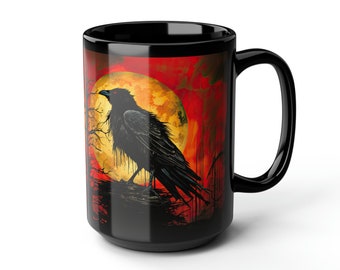 May include: Black coffee mug with a raven silhouette perched on a branch against a red and orange sunset background with a large yellow moon.