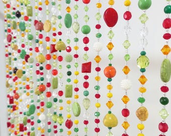 May include: A beaded curtain with strands of various colored beads, including red, green, yellow, orange, and clear. The beads are of different shapes and sizes, creating a colorful and textured look.