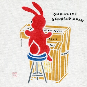 May include: A red rabbit figure playing a gold and black keyboard, seated on a blue and white stool. The artwork includes the text "ONDIO LINE SQUARED MODEL" in black, set against a white background.
