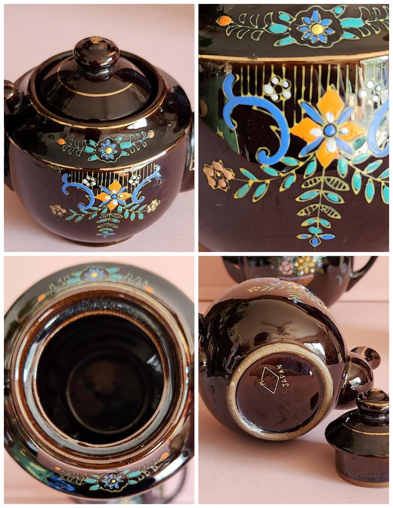 May include: A vintage brown ceramic teapot with a lid, featuring hand-painted floral and scroll designs in blue, orange, and teal. The teapot has a gold trim and is marked "JAPAN" on the bottom.
