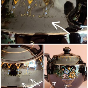 May include: Black vintage teapot with a lid, handle, and spout. The teapot features floral and geometric designs in gold, blue, and orange. The teapot has a glossy finish and a decorative design around the rim.