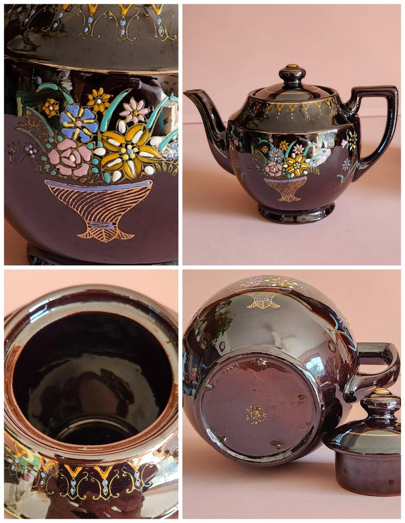 May include: A dark brown ceramic teapot with a lid, featuring a floral design in a basket. The teapot has a spout and handle, with gold accents along the rim and base. The floral design includes pink, yellow, blue, and white flowers.