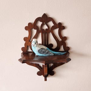 May include: A set of three ceramic mugs with a speckled, matte finish. Each mug features a different color: light blue, cream, and gray. The mugs have a simple, modern design with a rounded shape and a comfortable handle.