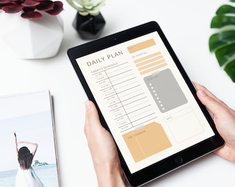 May include: A digital tablet displaying a daily planner with sections for today's schedule, to do list, and notes. The planner has a light brown and gray color scheme.