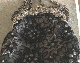 A vintage “ Stephanie” brand black beaded bag with chain.