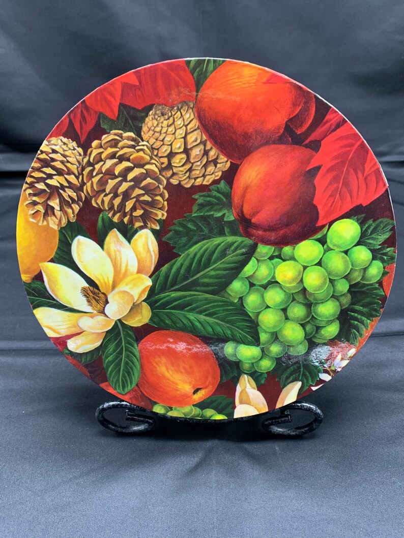 A Round Decorative Cardboard Storage Box Covered in Primarily Christmas